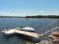 Heavy Duty steel truss leg dock with our aluminum stairs to transition over a rocky shoreline