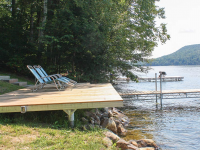 Shoreside platform used as a shore hitch for an articulating dock