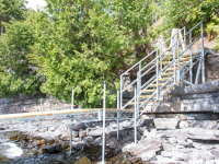 Steel stairs designed to transition over a rocky shoreline to our leg docks