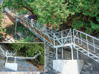 Freespan steel stairs with lower section that hinges for winter storage