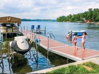 Medium duty aluminum docks with composite decking and 6,000 lb. vertical boat lift with Sunbrella canopy.