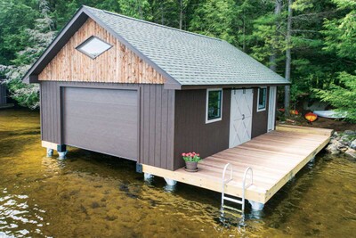 Our pile dock serves as the foundation for this enclosed boathouse (pile dock foundation & boathouse by The Dock Doctors)