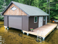 Our pile dock serves as the foundation for this enclosed boathouse (pile dock foundation & boathouse by The Dock Doctors)