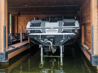Hydraulic boat lift installed in a boathouse