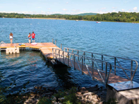 L-shaped custom floating dock and gangway - hitched to a concrete pad on the shoreline