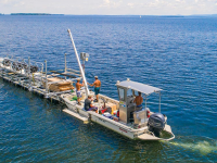 A boat lift and dock system being delivered to an island
