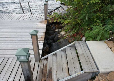 Concrete shore hinge system with stairs built into the dock frame