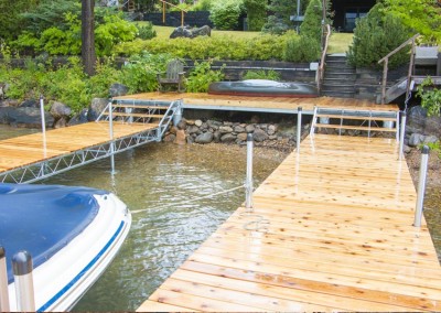 An articulating dock on Lake George attached to shoreside pile platform