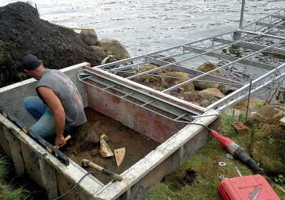 Concrete pad being installed for an articulating dock shore connection