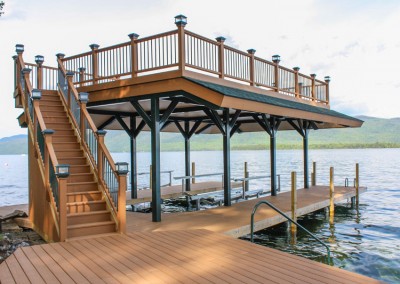 Pile dock with steel frame sundeck style boathouse & composite rails