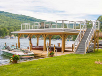 Boathouse with crib dock foundation and sundeck style roof