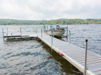 Medium duty aluminum leg docks with cedar decking and 2,000 lb. vertical boat lift