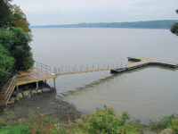 Heavy duty steel truss floating dock designed for extreme water fluctuation and heavy wave action