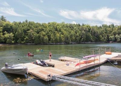 Steel truss floating dock with stiff arm anchor, PWC slip & kayak launch