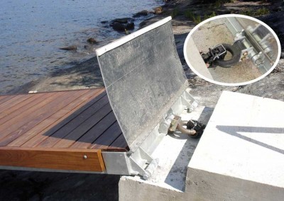 A concrete hitch pad with pintle shore hitch - aluminum tread plate in raised position