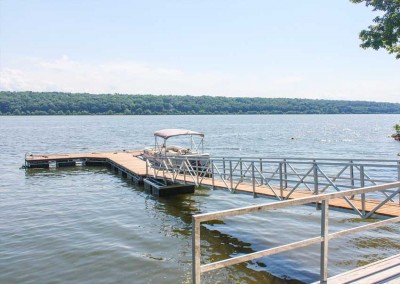 Floating dock in a river setting with our heavy duty permanent pile dock as a shore hitch
