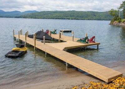 Pile dock with piles extending above the decking and rub strakes to protect watercraft - Huletts Landing (Lake George), NY