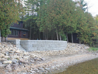 Stacked decorative concrete retaining wall and rip-rap erosion control