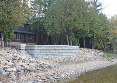 Stacked decorative concrete retaining wall and rip-rap erosion control 