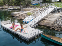 Aluminum floating dock and gangway with our custom pile dock as a shore hitch.